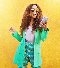 Image showing Fashion, phone and happy woman by a wall in the city while on a vacation or weekend trip. Travel, style and excited female from Brazil with a stylish, trendy and cool outfit networking on a cellphone