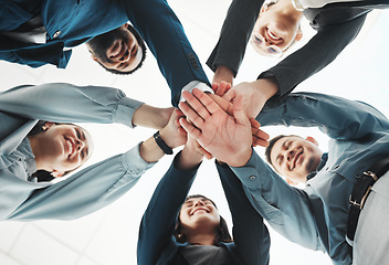 Image showing Business people, hands together and unity below for agreement, teamwork or collaboration at office. Low angle of group piling hand in team meeting, partnership or support and motivation at workplace