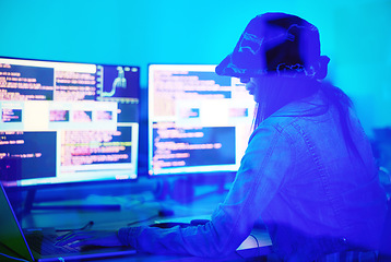 Image showing Hacker, programmer and woman typing on laptop in home at night in neon light to hack software. Cybersecurity, ransomware phishing and female coder coding on computer for hacking database with malware