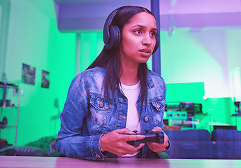Image showing Gamer, headphones and woman in home at night in neon light for web esports. Gaming, cyber technology and gen z female with controller playing online games, video game or multiplayer app on internet.