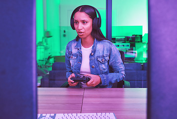 Image showing Headphones, gamer and woman on computer in home at night in green neon light for web esports. Gaming, technology and female with controller playing online games, multiplayer or video game in house.