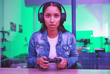 Image showing Gamer, headphones and portrait of woman in home at night in neon light for web esports. Gaming face, cyber technology and gen z female with controller playing online games and video game in house.