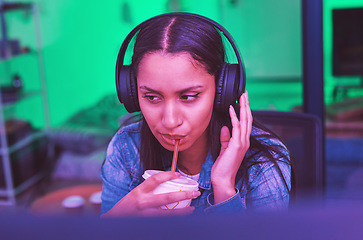 Image showing Gamer, headphones and drinking in neon home with bored, tired or annoyed face of girl in PC esports gaming. Woman programmer, drink and thinking in night basement and listening to music or radio