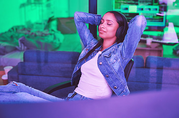 Image showing Woman, headphones or relax in neon house after technology coding, software development or cybersecurity safety. Happy, programmer or hands behind head in night programming success with music podcast