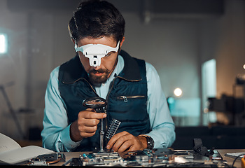 Image showing Technician, engineer and IT professional repair motherboard, microcircuit or electronic device in a workshop or shop. Person, man and guy fixing hardware of a computer for technology in a lab