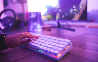 Image showing PC keyboard, gaming and hand for video game, online streaming and gamer room in neon light. Woman or person hands typing or press keys on gamer electronics, computer technology and rgb lights closeup