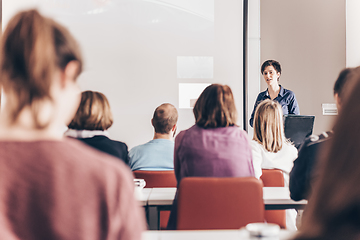 Image showing Woman giving presentation in lecture hall at university.