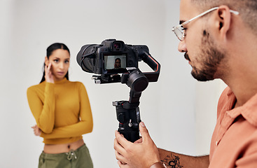 Image showing Photography, woman and photographer or cameraman with fashion model in studio for creative, capture and shoot. Media, backstage and professional man with camera, equipment and girl for photoshoot