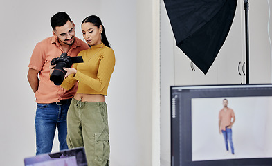 Image showing Teamwork, photographer and startup people with camera in studio set for shoot, magazine project or online content. Planning, focus or girl examine picture for digital catalog or fashion web design