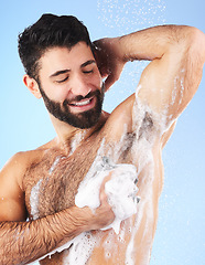 Image showing Wellness, man and foam for cleaning, morning routine for hygiene, grooming and daily washing on blue studio background. Male, guy or drops of aqua, showering for freshness, luxury or soap on backdrop