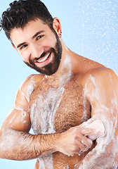 Image showing Shower, cleaning and portrait of man with soap, smile and water splash for wellness, hygiene and grooming. Skincare, health and male face with foam, cosmetics and washing body on blue background