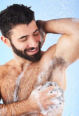 Image showing Showering, man and foam with arm pit, cleaning and skincare for dermatology and wet body against blue studio background. Male, gentleman and morning routine for daily hygiene and grooming on backdrop