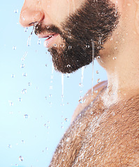 Image showing Man face, shower and profile of a model in water for cleaning, skincare and hygiene wellness. Isolated, blue background and studio with young person in bathroom for dermatology and beard self care