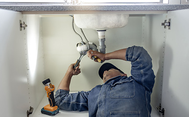 Image showing Plumber, man and handyman with plumbing, home renovation and manual labour with tools. Construction, DIY skills and professional, fixing pipe in industry and male with trade, repairs and maintenance