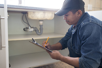 Image showing Plumber writing, sink maintenance document and plumbing check of a handyman in a kitchen. Water installation, home repair checklist and builder in a household for building construction and inspection