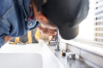 Image showing Plumber fixing faucet, plumbing and maintenance with man, manual labour and home renovation with trade. Construction, handyman with kitchen or bathroom sink with hardware, pipe and DIY with vocation