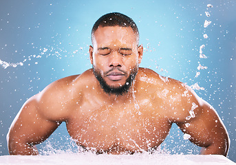 Image showing Water splash, cleaning or black man with face wash for skincare, fresh clean hygiene on studio background. African model in beauty, wellness and washing, grooming or cleansing for facial treatment