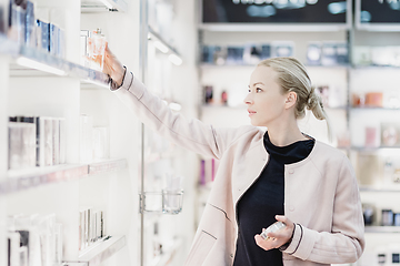 Image showing Beautiful woman shopping in beauty store.