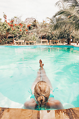 Image showing Caucasian lady floating in swimming pool.