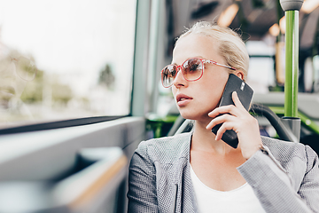 Image showing Blonde business woman traveling by bus.