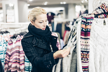 Image showing Beautiful woman shopping in clothing store.