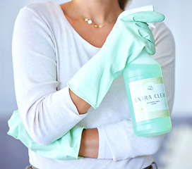 Image showing Cleaner with product for cleaning in hands, spray and chemical to clean with housekeeping and woman. Female housekeeper, gloves for safety from bacteria and disinfectant, bottle closeup and hygiene