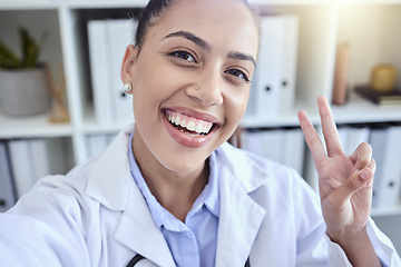 Image showing Woman, portrait smile and peace sign for selfie, profile picture or fun vlog in success at office. Happy female smiling for photo showing emoji, sign or friendly symbol in social media post at work