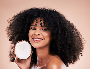 Image showing Black woman, studio portrait and coconut for beauty, smile and skincare for health, wellness or beige background. Happy african model, natural and fruit for aesthetic, healthy nutrition and cosmetics