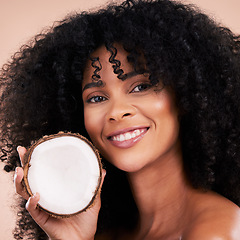 Image showing Black woman, studio portrait and coconut with smile, skincare and health with self care by beige background. Happy african model, face and fruit for natural aesthetic, healthy nutrition and cosmetic