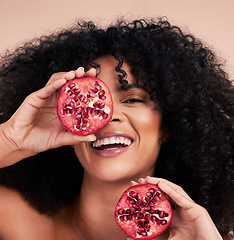 Image showing Black woman, studio portrait and pomegranate with smile, beauty and skincare for health, wellness and diet. Happy gen z model, african and fruit for aesthetic, healthy nutrition or glow by background