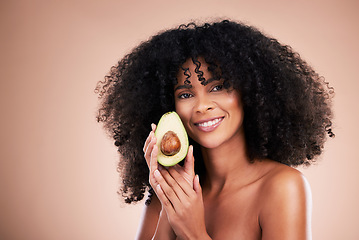 Image showing Black woman, studio portrait and avocado for beauty, cosmetic skincare or health for wellness, smile or self care. Happy gen z model, african or fruit for natural aesthetic, healthy nutrition or diet