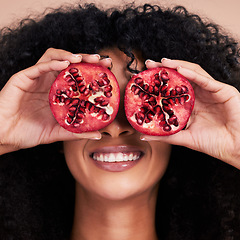 Image showing Hair care, face and black woman with pomegranate in studio isolated on a brown background. Fruit, skincare and happy female model holding food for healthy diet, nutrition or vitamin c and minerals.