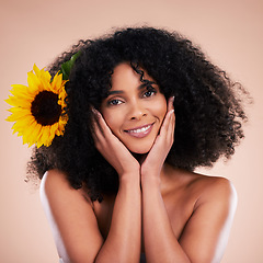 Image showing Black woman, studio portrait and sunflower with beauty, smile and cosmetic wellness by beige background. African gen z model, flower and spring aesthetic with hands, happy and natural makeup on face