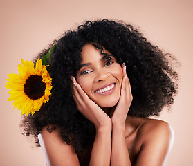 Image showing Black woman, studio portrait and sunflower with skincare, beauty or cosmetic wellness by beige background. African gen z model, flower and spring aesthetic with happiness, self care or natural makeup