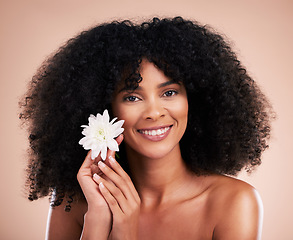 Image showing Black woman, studio portrait and flower with smile, beauty and cosmetic wellness by beige background. African gen z model, lotus plant and spring aesthetic with happiness, health and natural makeup