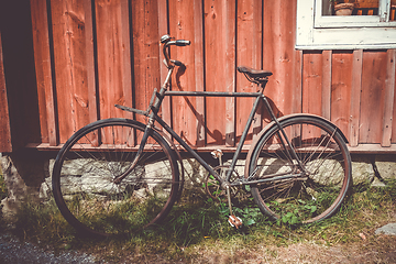 Image showing Old bicycle on a wooden wall