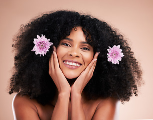 Image showing Face, portrait and black woman with flowers for hair care in studio isolated on a brown background. Floral cosmetics, hairstyle makeup and beauty of happy female model with plant for salon treatment.