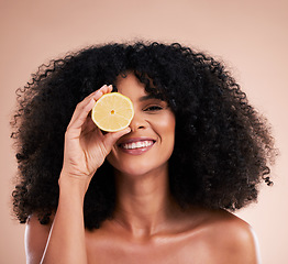 Image showing Hair care, face portrait and black woman with lemon in studio isolated on a brown background. Fruit, skincare and happy female model with lemons for healthy diet, nutrition or vitamin c and minerals.