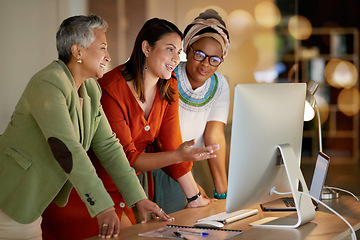 Image showing Computer, business and a woman manager with her team, working in collaboration at the office at night. Teamwork, diversity and coaching with a senior female manager training her staff at work