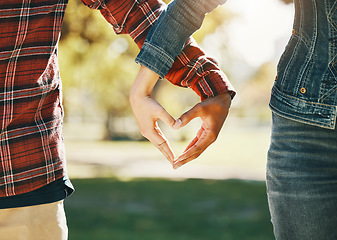 Image showing Love, interracial and hands of a couple in a heart for support, diversity and trust in nature. Emoji, marriage and gesture from a man and woman with emotion, romance and affection on valentines day