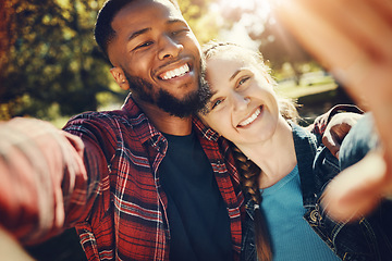 Image showing Diversity couple, love selfie and portrait outdoors, having fun and bonding together in nature. Comic smile, interracial romance and black man and woman take pictures for happy memory or social media