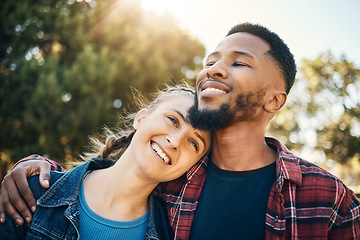 Image showing Young couple hug in park, summer and outdoor date together in sunshine, happiness and nature. Happy man hugging woman in garden for love, care and support with diversity partner, relax and smile face