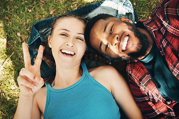 Image showing Interracial couple, park and portrait selfie for lying, relax or grass for smile, love or happiness on holiday. Black man, woman or profile picture on lawn for social media for romance, above or care