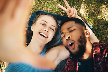 Image showing Peace sign selfie, couple and portrait smile at park outdoors, laughing at comic joke and bonding. Diversity, love romance and black man and woman with v hand emoji to take photo for happy memory.