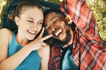 Image showing Interracial couple, park selfie and peace on grass with love, happiness and relax on holiday. Black man, woman and profile picture on lawn for social network app with romance, funny and comic time