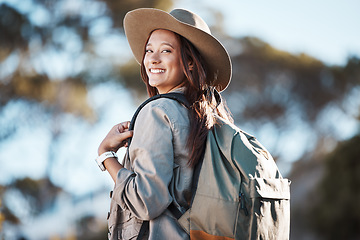 Image showing Hiking, portrait and woman in nature for freedom, travel and backpacking adventure on blurred background. Face, girl and traveler walking in a forest, smile and excited for journey, vacation or trip