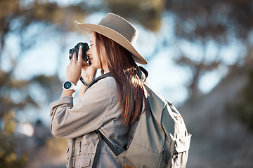 Image showing Woman, tourist and photography in hiking, adventure or backpacking journey for sightseeing in nature. Female hiker taking photo with camera for travel memory or mountain trekking to explore scenery