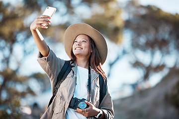 Image showing Woman, tourist and smile for travel selfie on hiking adventure, backpacking journey or profile picture in nature. Female hiker smiling for photography, memory photo or scenery in mountain trekking