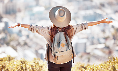 Image showing Girl, mountain and hands open with cityscape, back and training for holiday, summer and wellness with sky. Woman, travel and achievement with city skyline, buildings and happiness in morning sunshine
