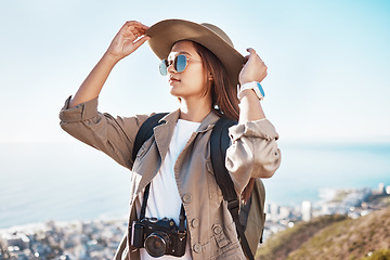 Image showing Travel, photographer and woman with camera in nature, happy and relax on adventure on blue sky background. Freedom, photography and girl student backpacking, sightseeing and solo trip in South Africa